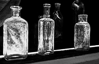 Six bottles photographed through a window.